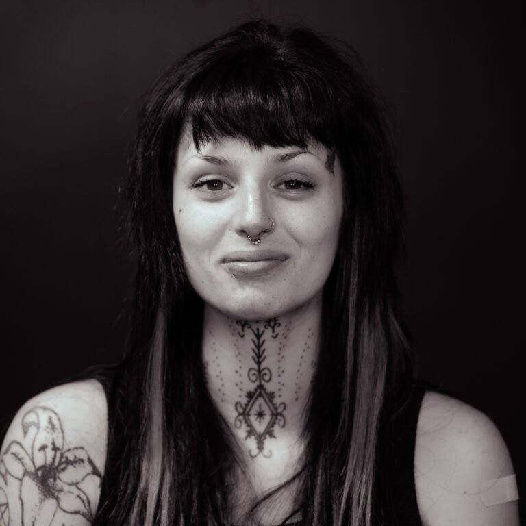 Portrait of Adrienne, tattoo artist at Tattoo Lab Studios Halifax, known for detailed linework, floral, and illustrative tattoos.